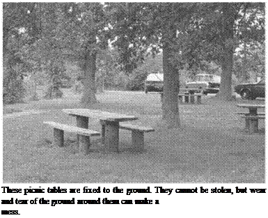 Подпись: These picnic tables are fixed to the ground. They cannot be stolen, but wear and tear of the ground around them can make a mess. 